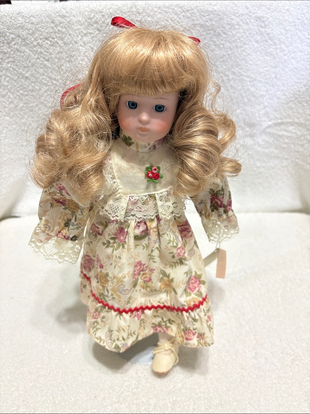 Porcelain Blonde Curly-Hair Doll in Floral Cream Dress with Pink Trim